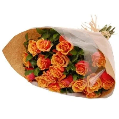 Bouquet of orange and red roses wrapped in brown paper with white tissue on a white background