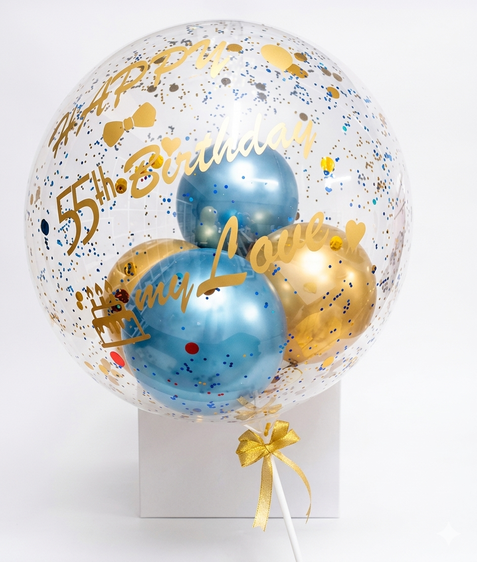 Clear bubble balloon with blue and gold balloons, confetti, and 'Happy Birthday' text on a white background.
