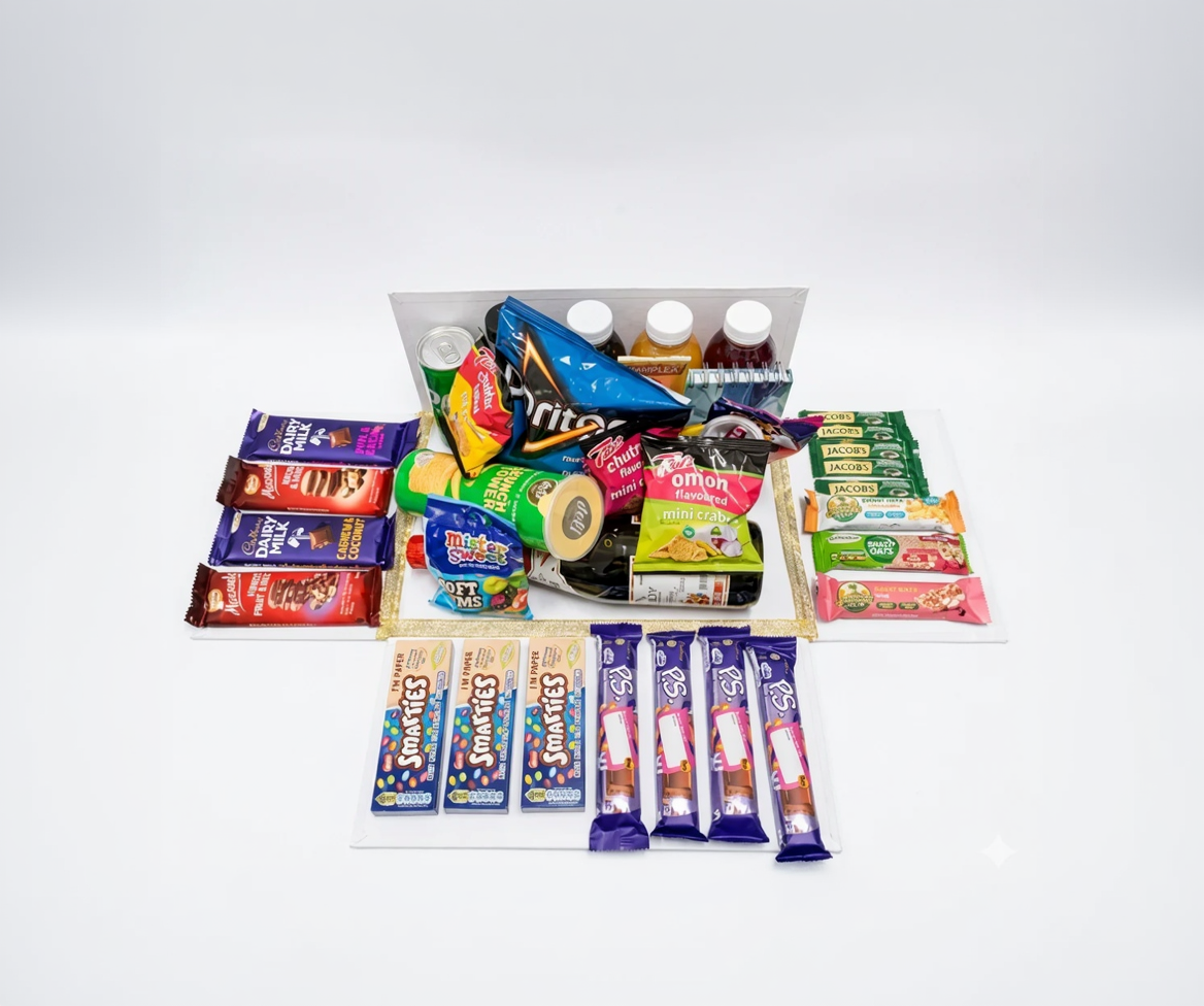 Assorted snack items including chips, drinks, and candy bars on a white background