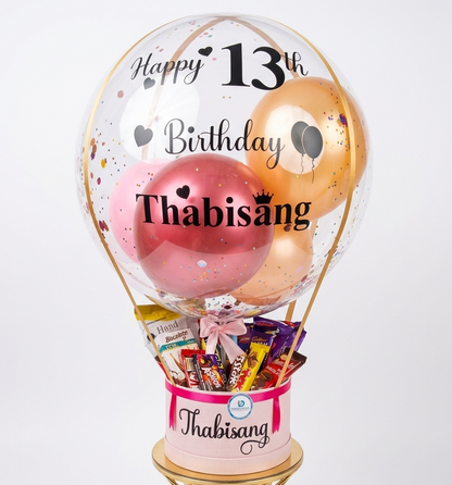 Personalized birthday balloon with candy inside on a white background