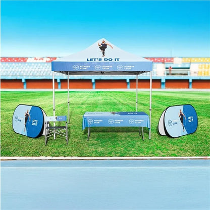 Outdoor Display setup with a branded canopy, table, and chairs on a sports field.