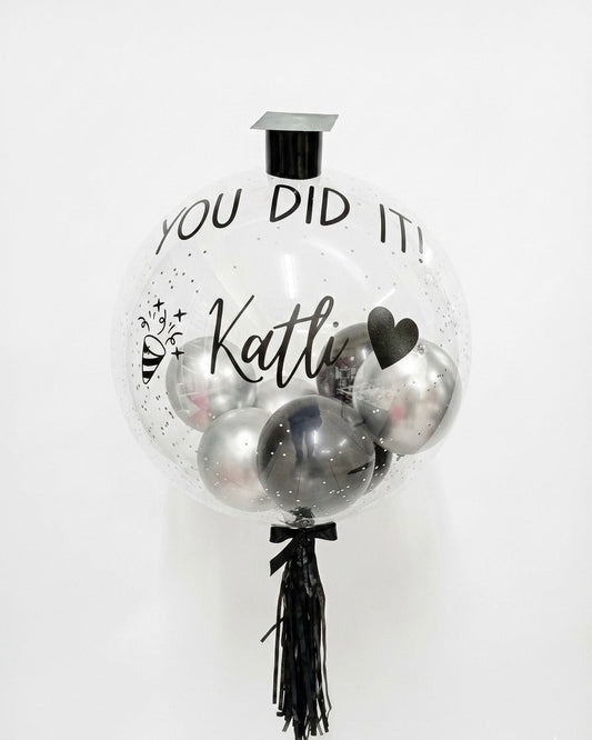 Decorative balloon with 'You Did It! ' text on a white background