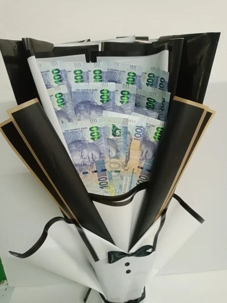 Faux bouquet made of 100 Rand banknotes in a black holder.
