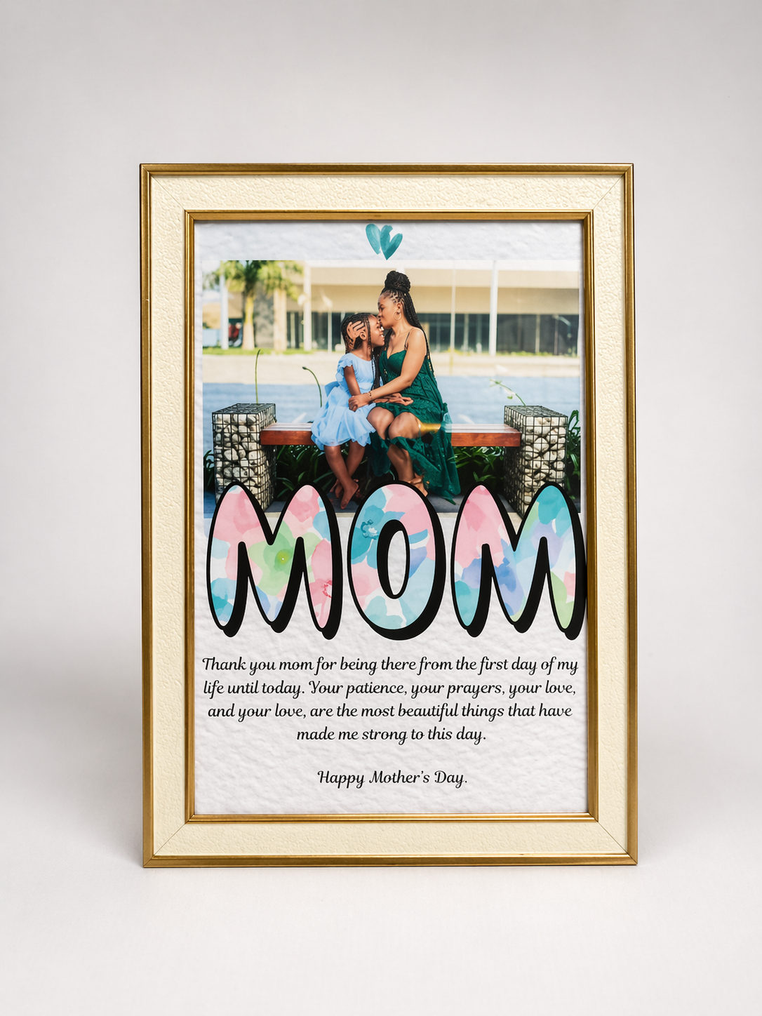 Framed photo of a mother and daughter with 'MOM' text on a white background