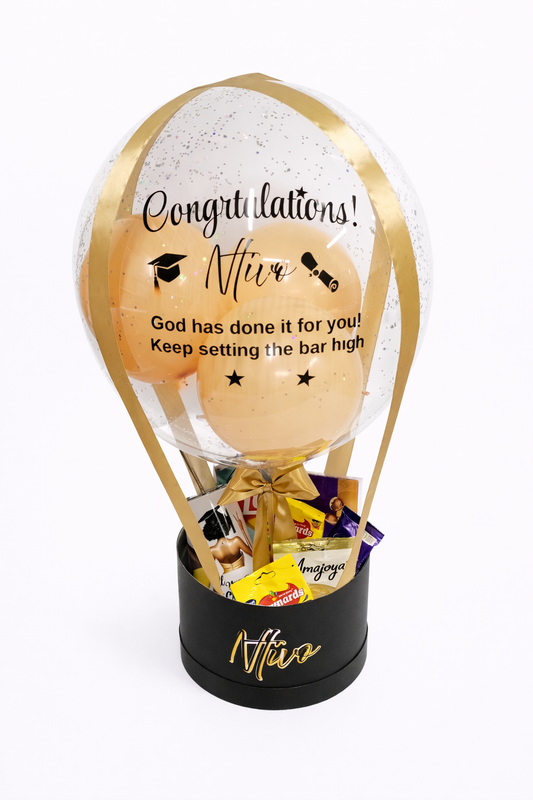 Hot air balloon-shaped gift with 'Congratulations' message and candy inside on a white background