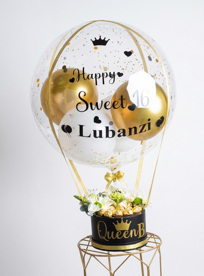 Decorative balloon with 'Happy Sweet 16 Lubanzi' text, gold and black theme, on a white background.