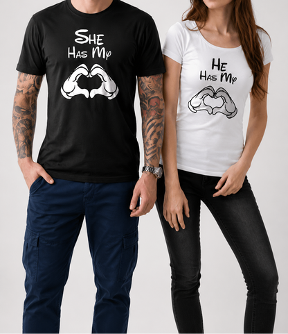 Man and woman wearing matching t-shirts with 'She Has My' and 'He Has My' text and graphic design.