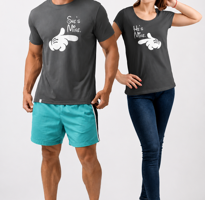 Two people wearing matching dark gray t-shirts with a graphic design on a white background