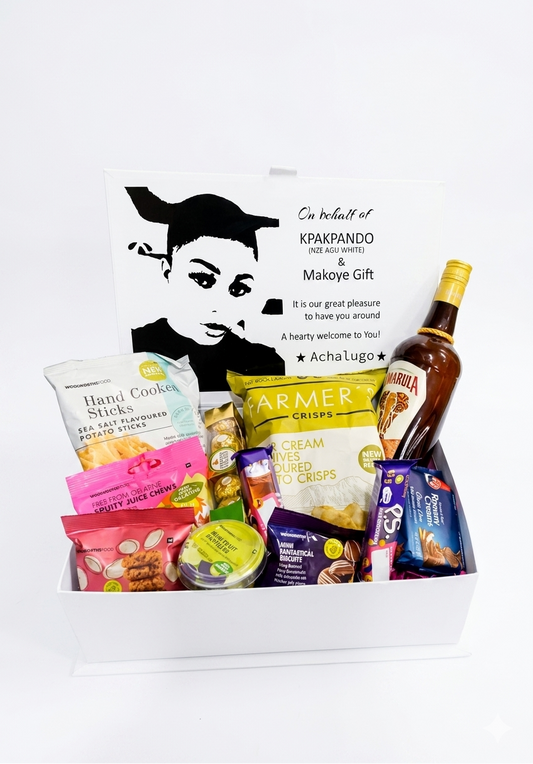 Gift basket with snacks and a bottle of alcohol on a white background