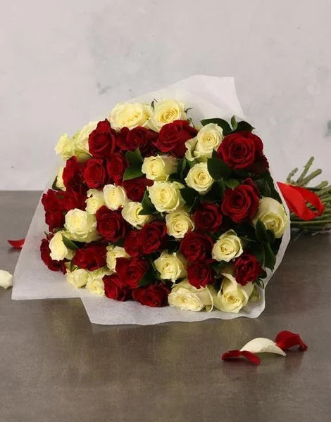 Bouquet of red and white roses on a gray surface