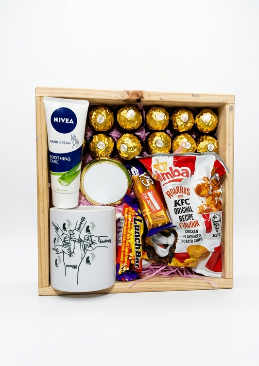 Gift box with Nivea cream, Ferrero Rocher chocolates, KFC snack pack, and a mug on a white background