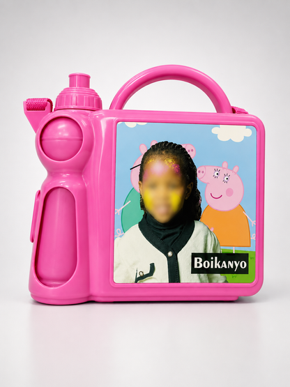 Pink toy lunch box with a character from Peppa Pig on a white background