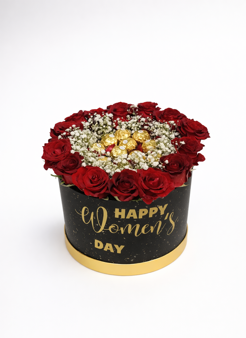Floral arrangement with red roses and gold candies in a box labeled 'Happy Women's Day' on a white background
