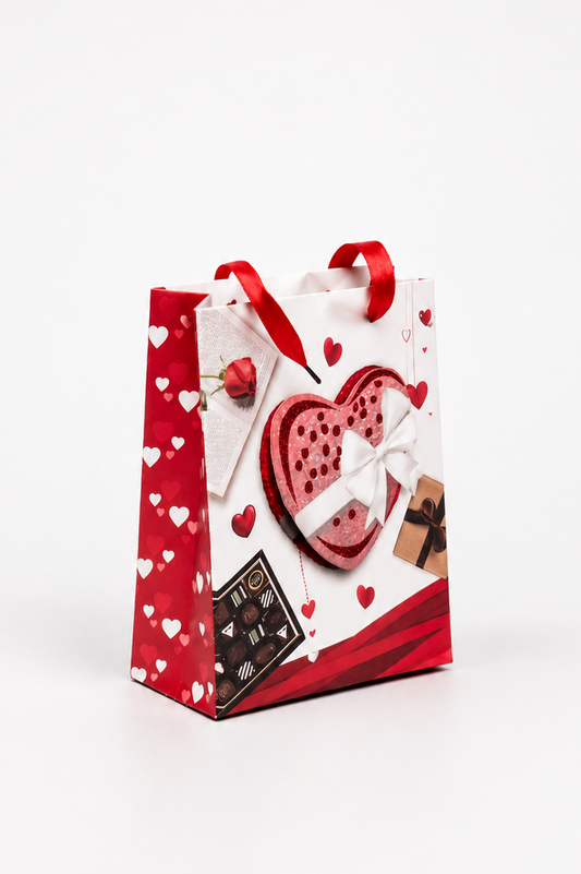 Gift bag with heart designs and a chocolate bar on a white background
