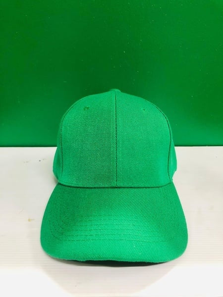 Green cap on a white surface with a green background.  Gifting in Pretoria.