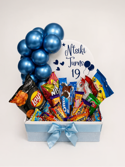 Gift basket with snacks and balloons, personalized for a 19th birthday, on a white background.