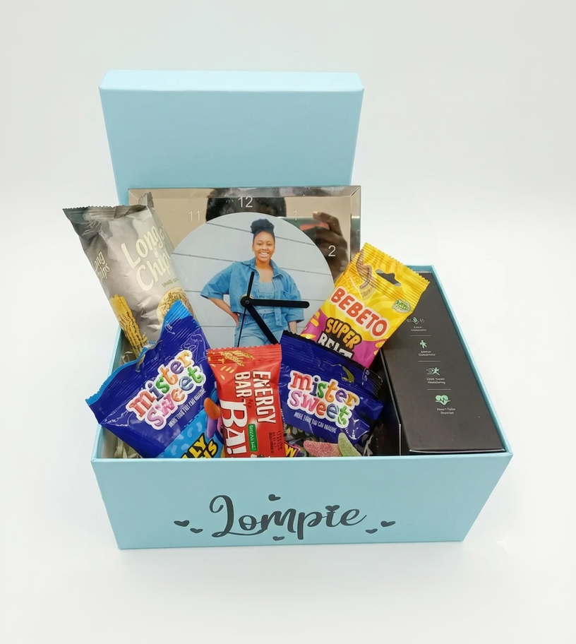 Gift box with snacks and a photo of a woman on a white background