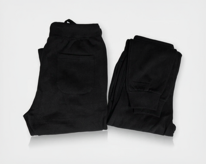 Two pairs of black pants on a white background