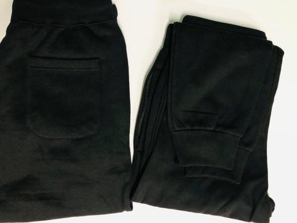 Black sweatpants displayed on a white background.  Gifting in Pretoria.