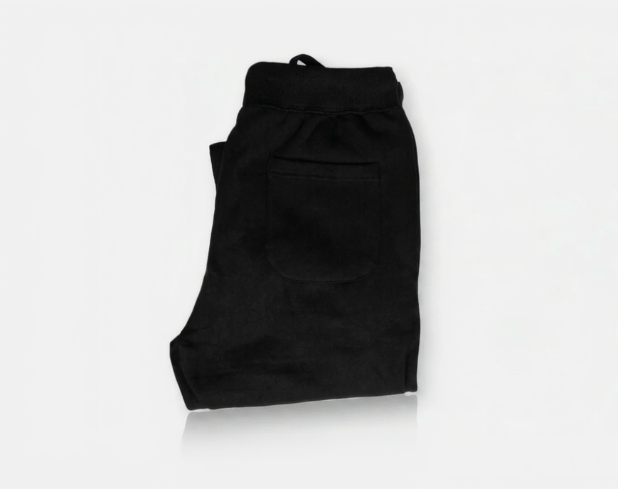 Folded black pants on a white background