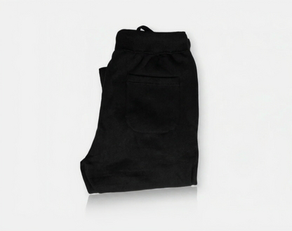 Folded black pants on a white background
