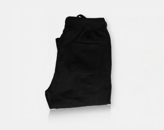 Folded black pants on a white background