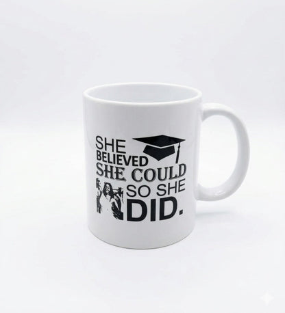 White mug with motivational quote and graduation cap design on a white background