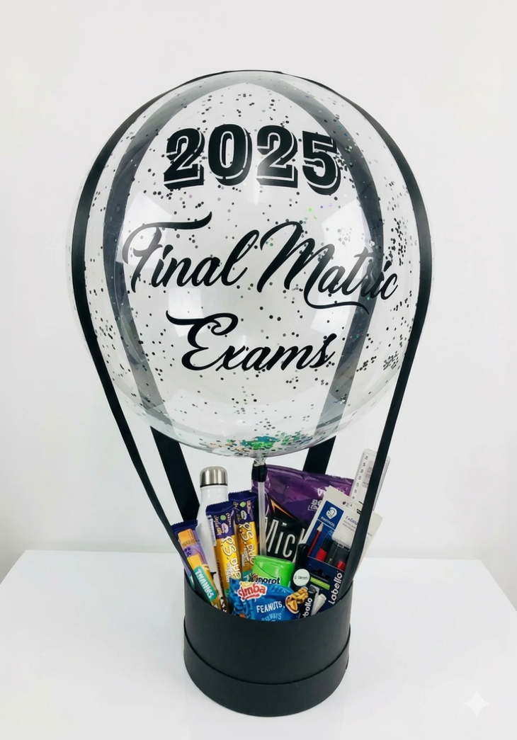 Clear snow globe with '2025 Final Matric Exams' text, filled with stationery and snacks.